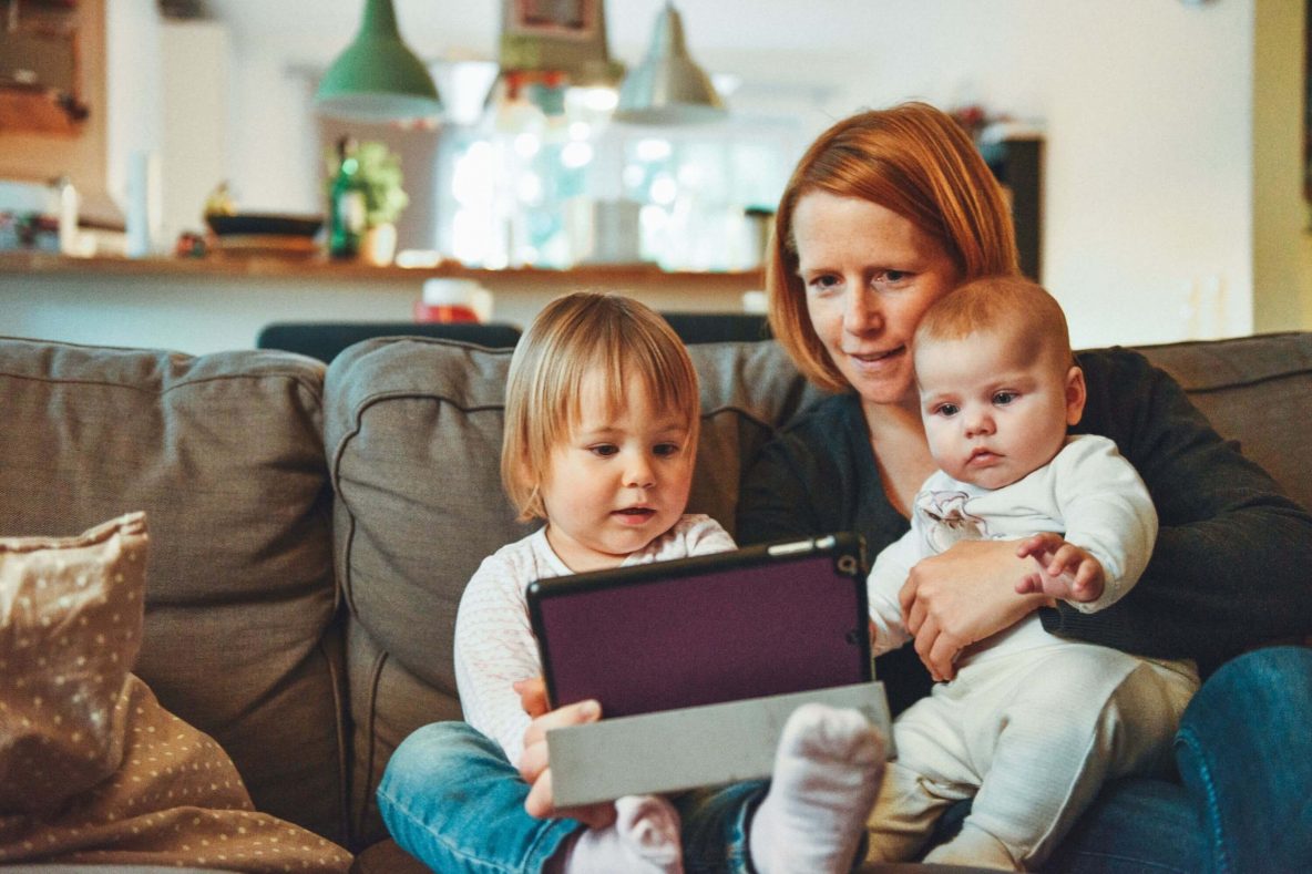 Mum and two young children using an ipad tablet
